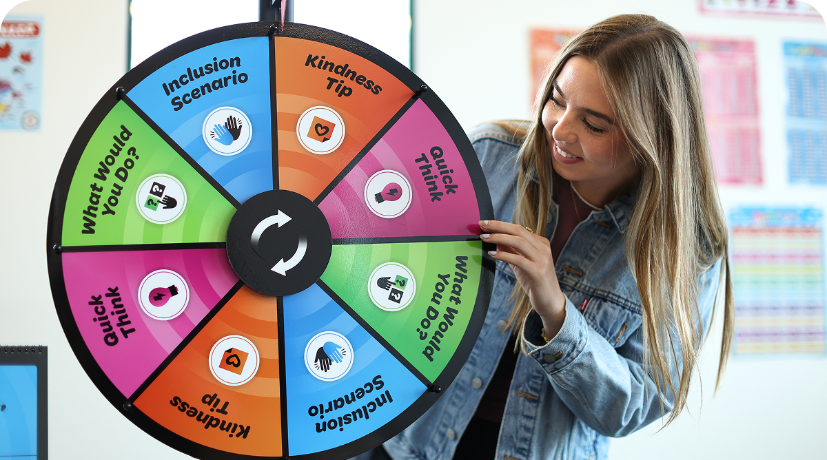 Facilitator spinning the Spinclusion wheel in a classroom