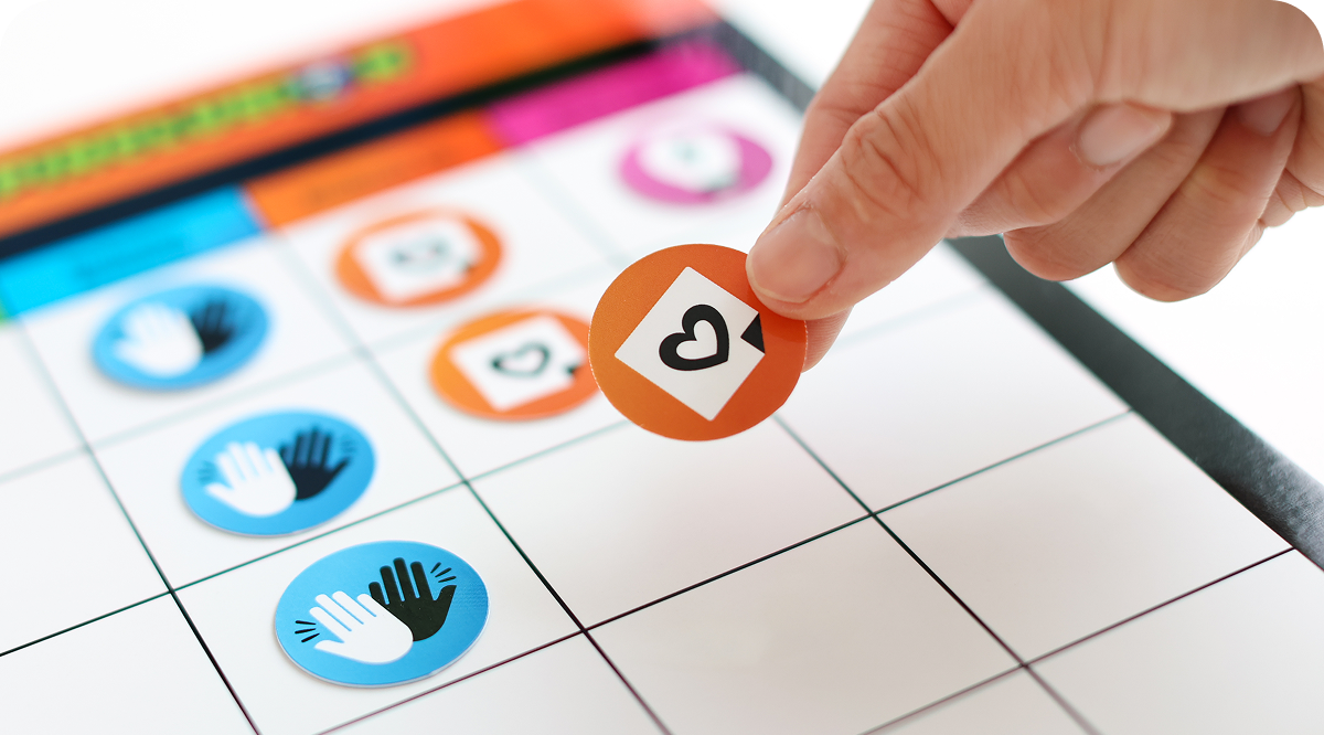 Hand placing a token on the Spinclusion game board