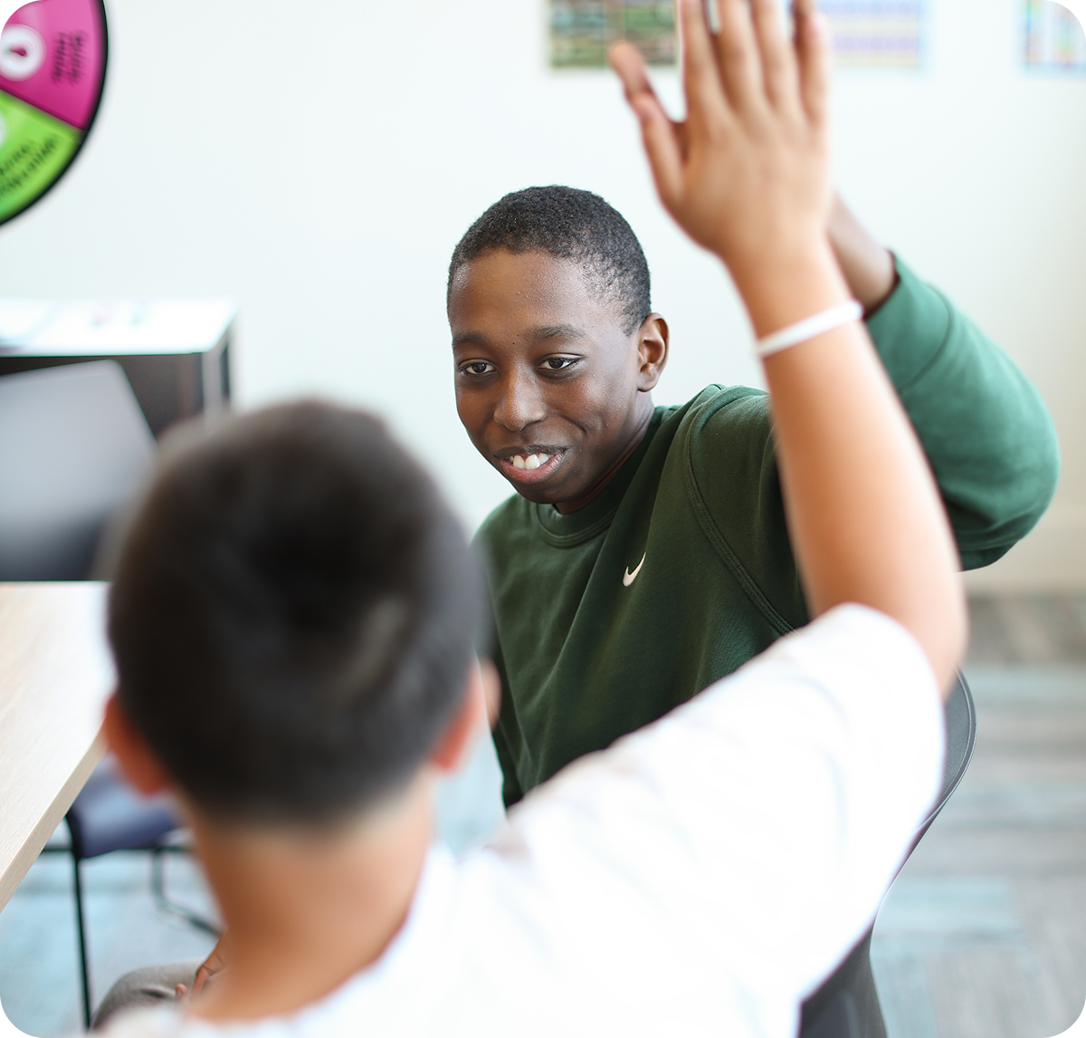 Two students sharing a high five